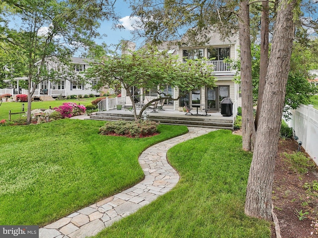 view of yard with a balcony