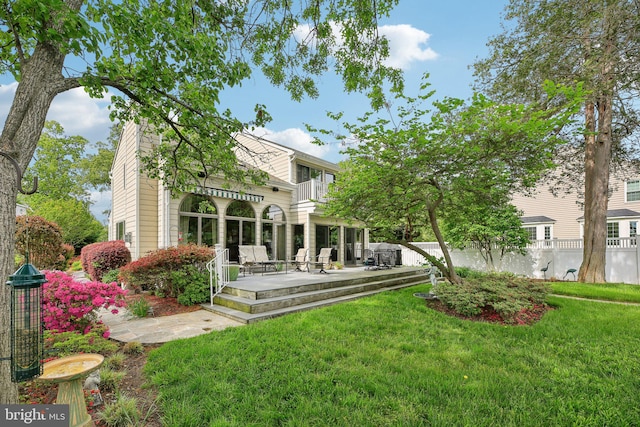 rear view of property featuring a chimney and a deck