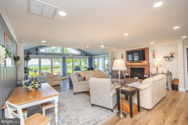 living room featuring recessed lighting, ornamental molding, light wood finished floors, visible vents, and a brick fireplace