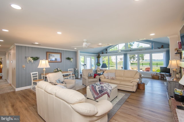 living room featuring wood finished floors, a ceiling fan, baseboards, ornamental molding, and recessed lighting