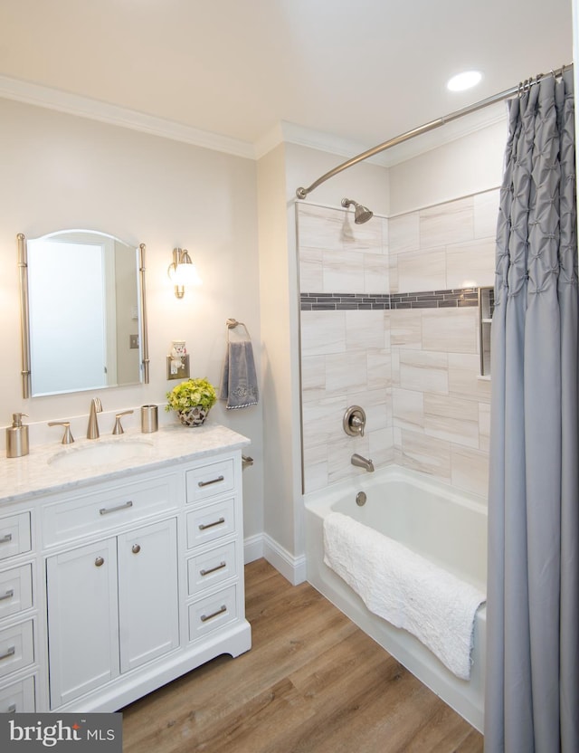 bathroom featuring shower / tub combo, baseboards, vanity, crown molding, and wood finished floors