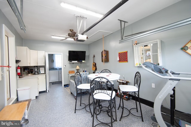 dining room with ceiling fan, independent washer and dryer, and speckled floor