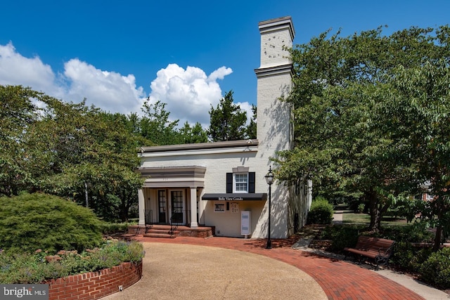 view of front facade featuring a chimney