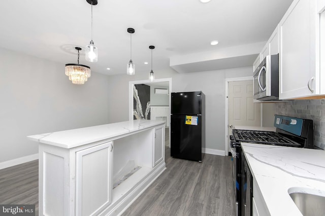 kitchen featuring white cabinets, appliances with stainless steel finishes, baseboards, and wood finished floors