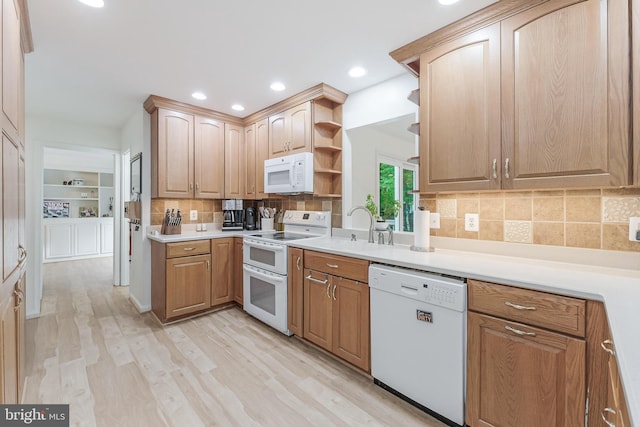 kitchen with a sink, white appliances, open shelves, light wood-style flooring, and backsplash