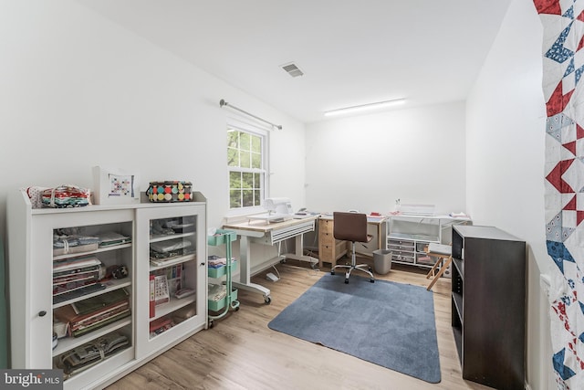 office area with visible vents and wood finished floors