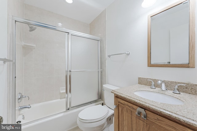 full bathroom featuring vanity, toilet, and enclosed tub / shower combo