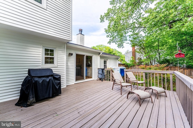wooden deck featuring area for grilling and a fenced backyard