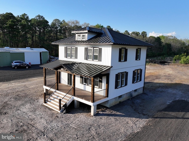 711 Tuckahoe Rd, Vineland, NJ 08360 - view of front of home with a porch, stairs, an outbuilding, metal roof, and a standing seam roof