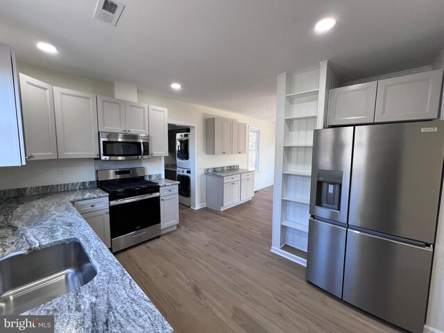 711 Tuckahoe Rd, Vineland, NJ 08360 - kitchen featuring a sink, open shelves, stainless steel appliances, visible vents, and light stone countertops