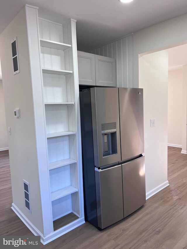 711 Tuckahoe Rd, Vineland, NJ 08360 - kitchen featuring open shelves, stainless steel fridge, baseboards, and wood finished floors