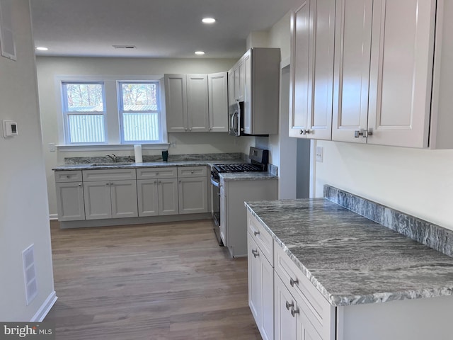 711 Tuckahoe Rd, Vineland, NJ 08360 - kitchen with a sink, stainless steel appliances, light wood-style flooring, and visible vents