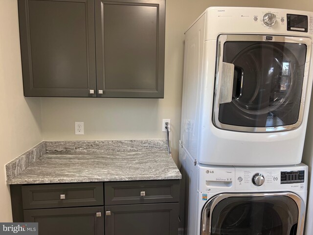 711 Tuckahoe Rd, Vineland, NJ 08360 - laundry area featuring stacked washer and clothes dryer and cabinet space