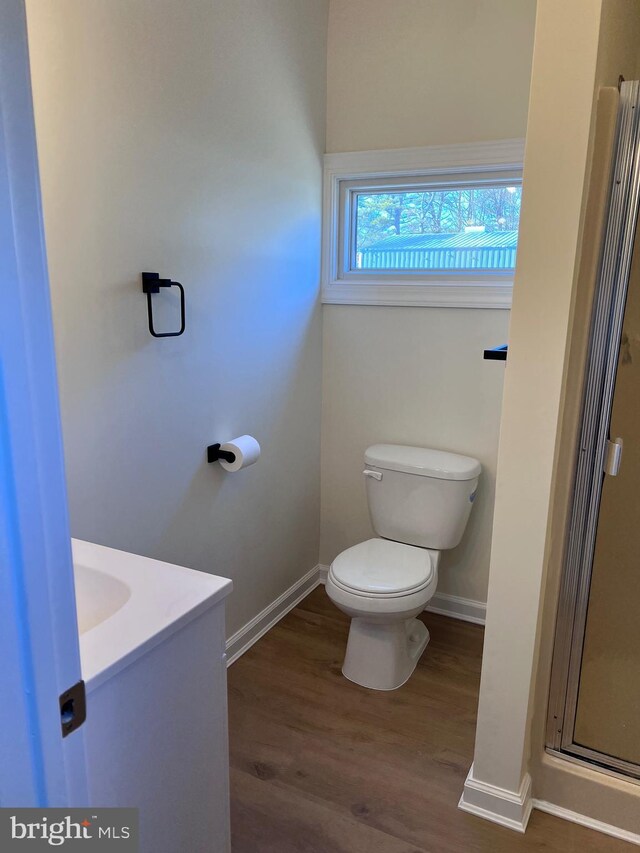 711 Tuckahoe Rd, Vineland, NJ 08360 - full bath with toilet, wood finished floors, vanity, a stall shower, and baseboards