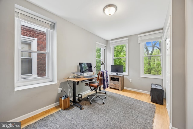 home office featuring baseboards and wood finished floors