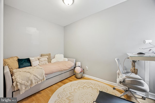 interior space with baseboards and wood finished floors