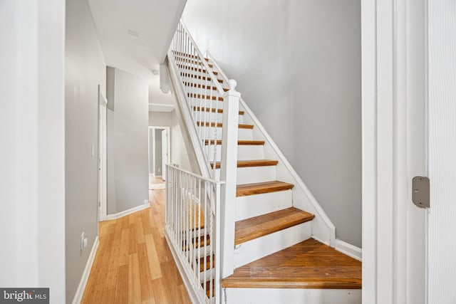 stairs with baseboards and wood finished floors