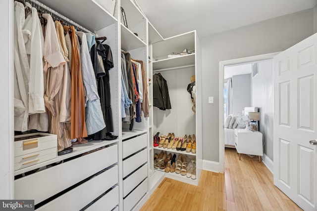 walk in closet with light wood-style flooring and visible vents