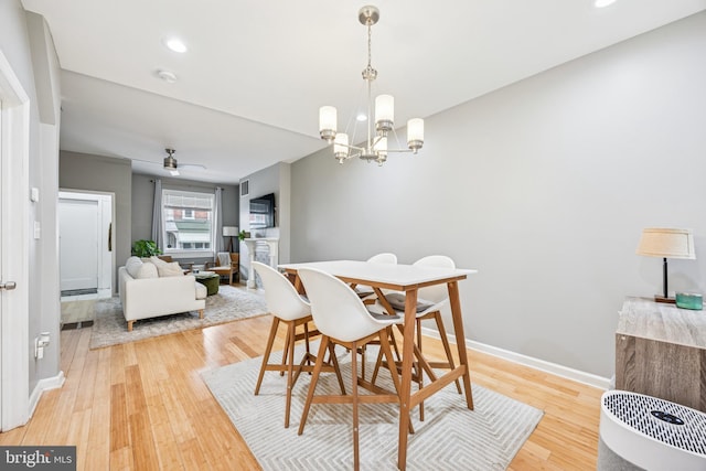 dining area with baseboards, light wood-style floors, and recessed lighting