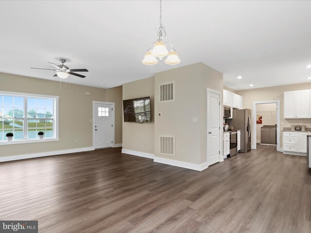 unfurnished living room with baseboards, dark wood-type flooring, ceiling fan, recessed lighting, and a chandelier