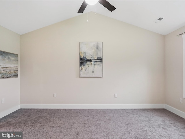 spare room with carpet flooring, ceiling fan, baseboards, and vaulted ceiling