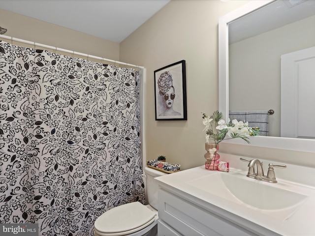 bathroom featuring vanity, toilet, and a shower with curtain