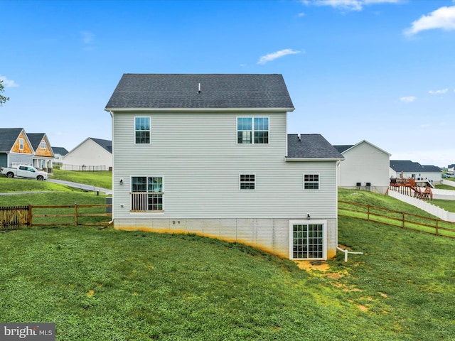 back of house featuring a shingled roof
