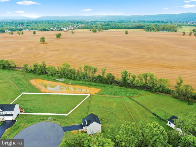 aerial view of sparsely populated area with a water and mountain view