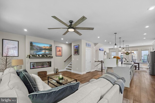 1653 Bandit Loop, Reston, VA 20190 - living area featuring stairs, wood finished floors, recessed lighting, a ceiling fan, and baseboards