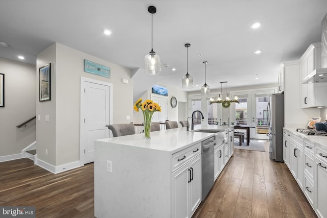 1653 Bandit Loop, Reston, VA 20190 - kitchen featuring appliances with stainless steel finishes, a kitchen island with sink, dark wood-style flooring, light countertops, and recessed lighting