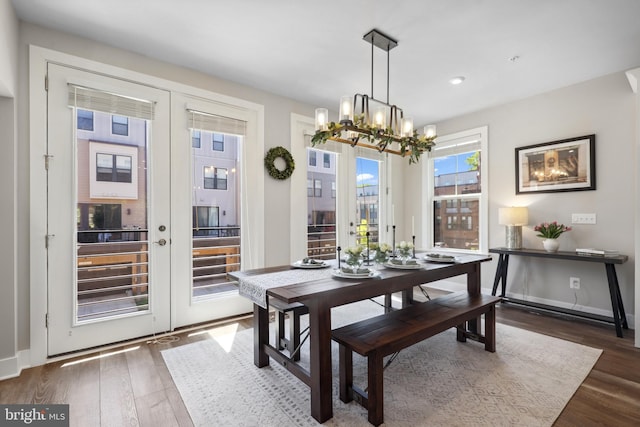 1653 Bandit Loop, Reston, VA 20190 - dining area with a chandelier, dark wood finished floors, french doors, recessed lighting, and baseboards