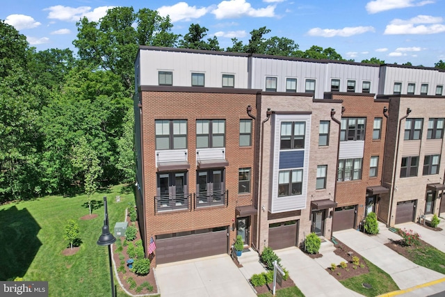 1653 Bandit Loop, Reston, VA 20190 - multi unit property with an attached garage, concrete driveway, brick siding, and a front lawn