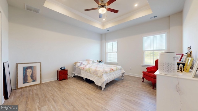 21042 Wavecrest Ter Unit 23, Lewes, DE 19958 - bedroom with light wood-type flooring, a tray ceiling, and visible vents