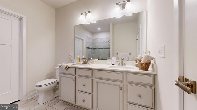 21042 Wavecrest Ter Unit 23, Lewes, DE 19958 - full bathroom with a tile shower, toilet, double vanity, and a sink