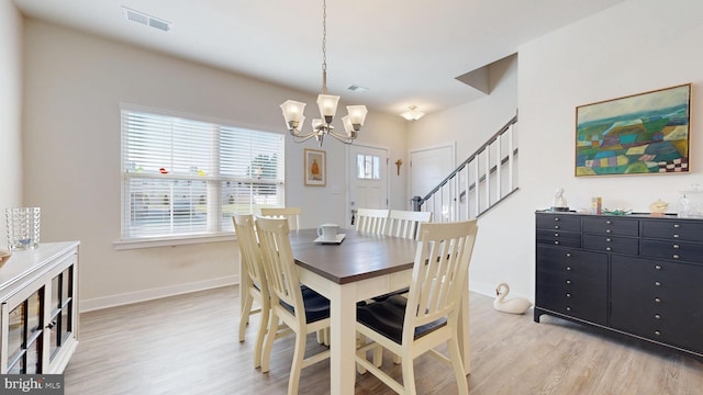 21042 Wavecrest Ter Unit 23, Lewes, DE 19958 - dining room featuring light wood finished floors, visible vents, baseboards, and a notable chandelier