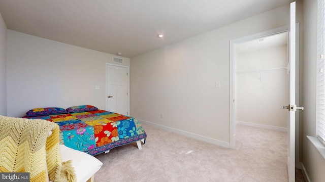 21042 Wavecrest Ter Unit 23, Lewes, DE 19958 - bedroom featuring a closet, carpet, baseboards, visible vents, and a walk in closet