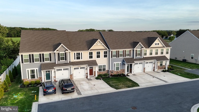 21042 Wavecrest Ter Unit 23, Lewes, DE 19958 - view of property with concrete driveway, a garage, and stone siding