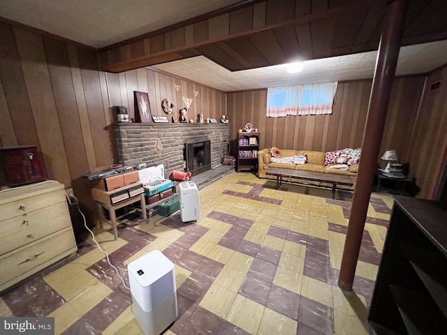 living area featuring a fireplace and wooden walls