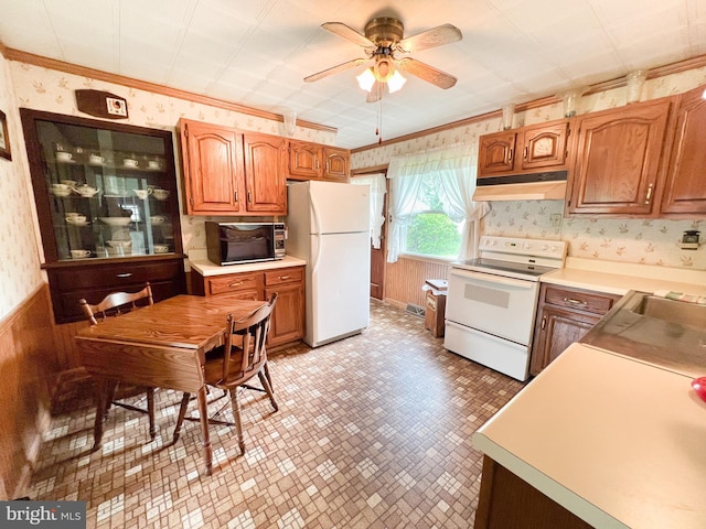 kitchen with wallpapered walls, under cabinet range hood, white appliances, ceiling fan, and brown cabinets