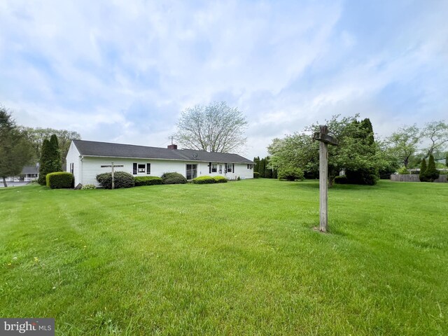 exterior space with a yard and a chimney