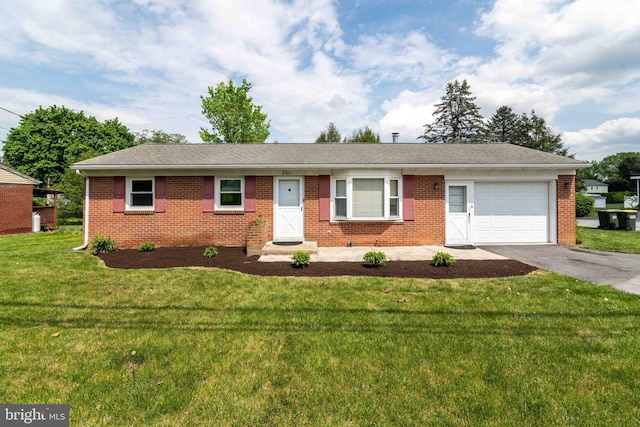 ranch-style home with an attached garage, brick siding, asphalt driveway, and a front lawn