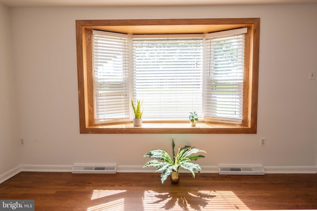 detailed view of baseboards and wood finished floors