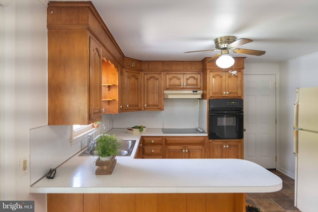 kitchen with black appliances, a sink, under cabinet range hood, light countertops, and a ceiling fan