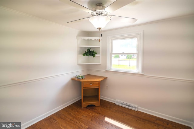 unfurnished room featuring baseboards, ornamental molding, wood finished floors, and ceiling fan