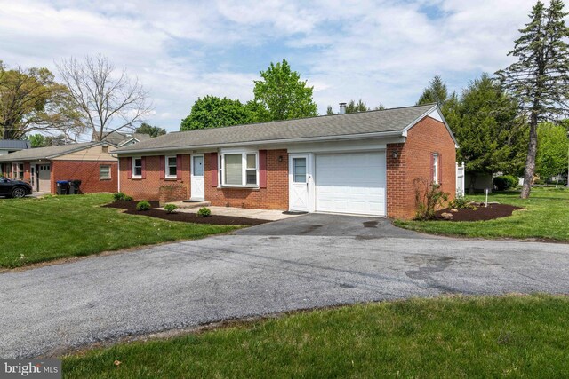 single story home featuring an attached garage, brick siding, asphalt driveway, and a front lawn