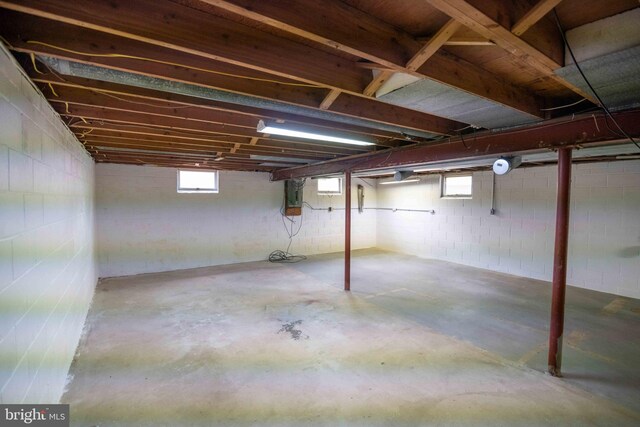 below grade area featuring concrete block wall