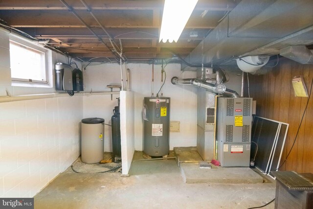 below grade area featuring electric water heater and wooden walls