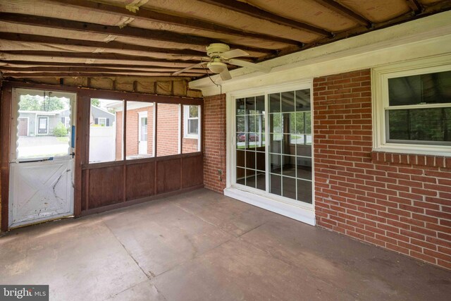 unfurnished sunroom with a ceiling fan and healthy amount of natural light