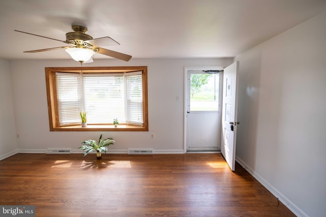 entryway featuring wood finished floors, ceiling fan, and baseboards