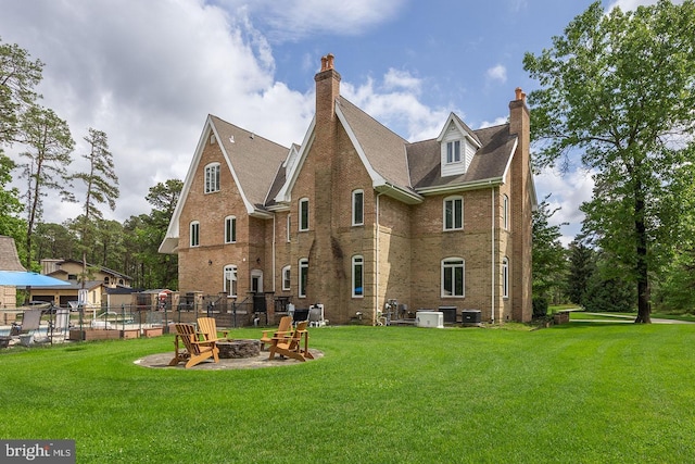 22 Grassy Lake Rd, Shamong, NJ 08088 - back of property with a chimney, a fire pit, brick siding, and central air condition unit